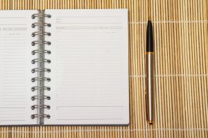 open calendar planner and a pen